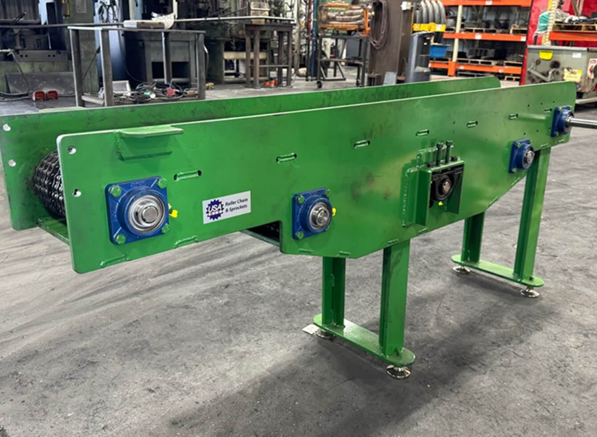 Green industrial conveyor belt system in a warehouse setting